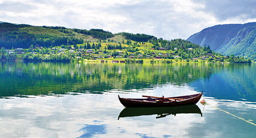 A small boat on the fjord in Ulvik, Norway A small boat on the fjord in Ulvik, Norway