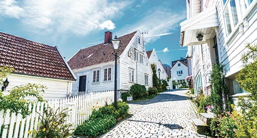 White houses lining a cobbled street in Stavanger, Norway