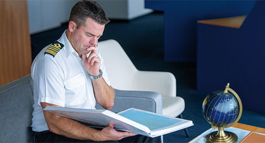 Captain Tanner choosing ports for his mystery cruise