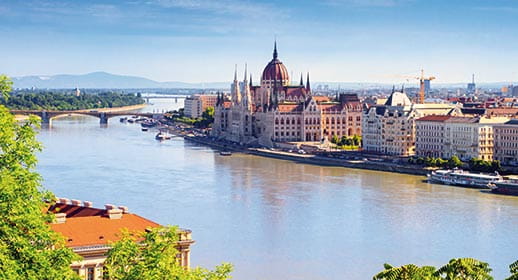 A view across the Danube River to the Budapest Parliament Building in Hungary A view across the Danube River to the Budapest Parliament Building in Hungary