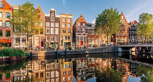 Traditional Dutch houses by a canal in Amsterdam