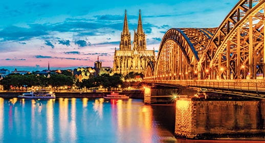 A view across the Rhine River towards the city of Cologne at sunset