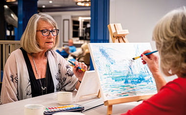 Friends painting in the Craft Room on Spirit of Adventure
