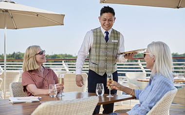 Guests enjoying drinks served on the Verandah on Spirit of Adventure