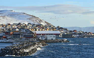 Jetty from rocks at the harbor entrance, behind the village, Honningsvåg, Magerøya island