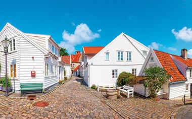 A cobbled street in Stavanger lined with white houses, Norway