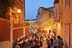 A view down a street in the Calcada do Duque towards the Sao Jorge castle at twilight in Lisbon, Portugal