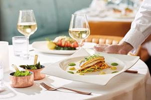A seabass fillet served with vegetable linguini, pea puree and saffron butter sauce at Coast to Coast on-board Spirit of Discovery