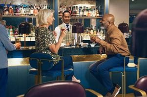 A couple enjoying drinks on Spirit of Adventure