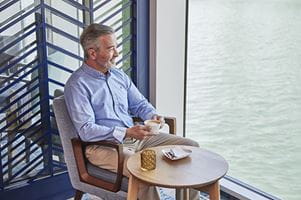 A man enjoying coffee whilsy cruising solo on Spirit of the Rhine