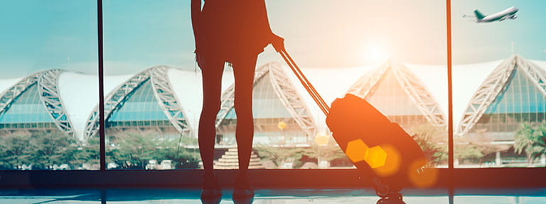 A woman standing in an airport terminal