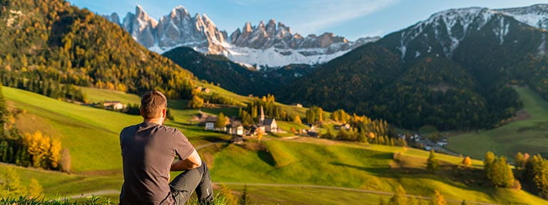 A man taking in the view in Trentino Alto Adige, Italy