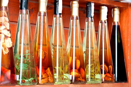 Colourful liqueur and vinegar bottles on a Croatian market