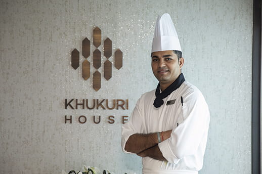 1st cook Shovan Gautam standing by Khukuri House Nepalese Speciality Restaurant