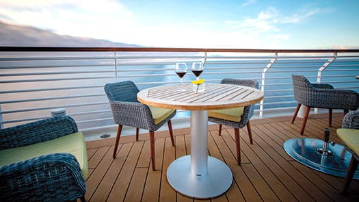 Glasses of red wine on a table on the Verandah aboard Spirt of Discovery